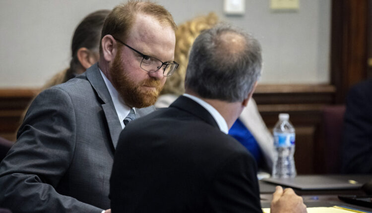 Defendant Travis McMichael speaks with his attorney Bob Rubin while they wait for the jury to return to the courtroom during the trial of McMichel and his father, Greg McMichael, and a neighbor, William "Roddie" Bryan in the Glynn County Courthouse, Wednesday, Nov. 24, 2021, in Brunswick, Ga. The three are charged with the February 2020 slaying of 25-year-old Ahmaud Arbery. (AP Photo/Stephen B. Morton, Pool)
