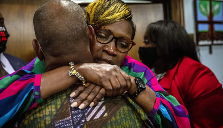 Ahmaud Arbery’s mother, Wanda Cooper-Jones his hugged by a supporter after the jury convicted Travis McMichael in the trial of McMichael, his father, Greg McMichael, and neighbor, William “Roddie” Bryan, Wednesday at Glynn County Courthouse. The three defendants were found guilty Wednesday in the death of Ahmaud Arbery. AP Photo/Stephen B. Morton, Pool