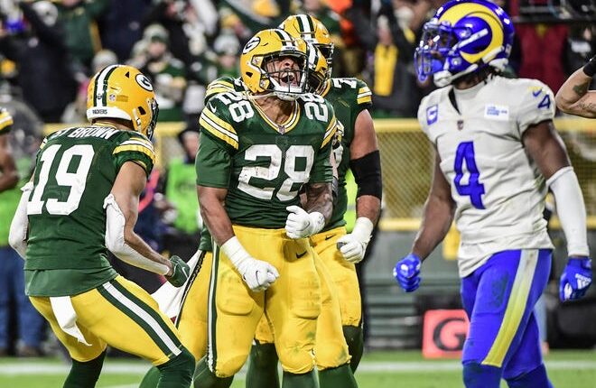 Green Bay Packers running back AJ Dillon (28) reacts after scoring a touchdown in the third quarter against the Los Angeles Rams at Lambeau Field.