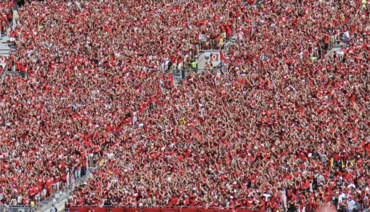 Students dancing and jumping around in sections O and P while the song "Jump Around" plays between the 3rd and 4th quarters at w:Camp Randall Stadium for a Wisconsin Badgers football game