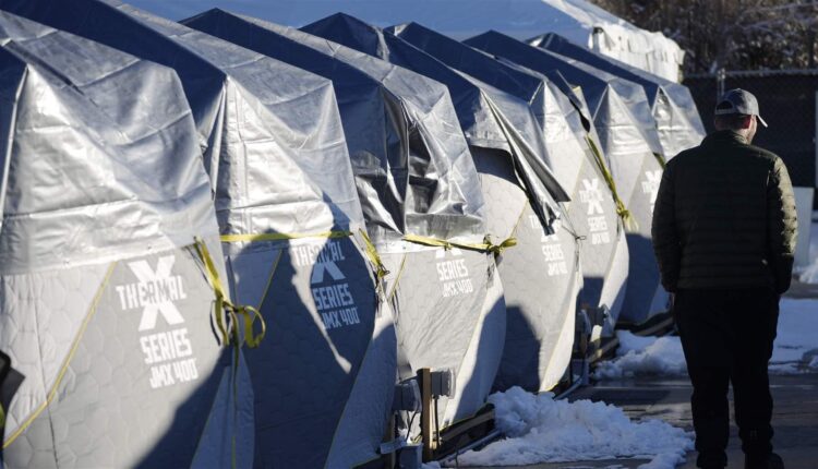 In this February photo, tents stand in a long row at a city-sanctioned homeless encampment in Denver. As homeless encampments have become increasingly visible in recent years, at least six states have turned to legislation written by a Texas-based think tank advocating for state-sanctioned camps, bans on unofficial encampments and penalties against cities that refuse to remove them. 