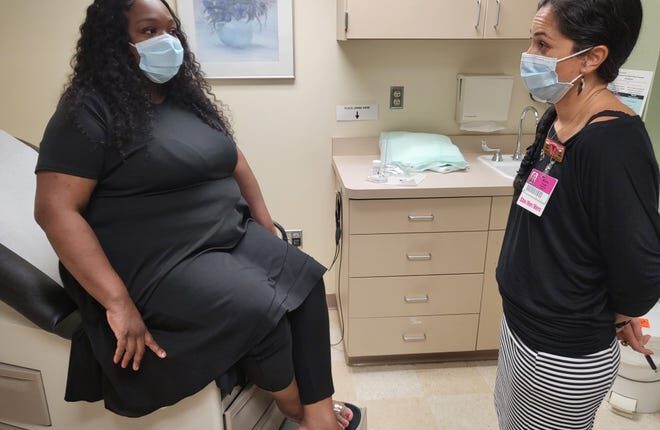 Therese Jones, 44, talks with her OB-GYN, Dr.  Marie Forgie, in an exam room at Aurora Sinai Medical Center.  Jones opted for a newer, less-invasive procedure to remove fibroids that helped her avoid a more major surgery.