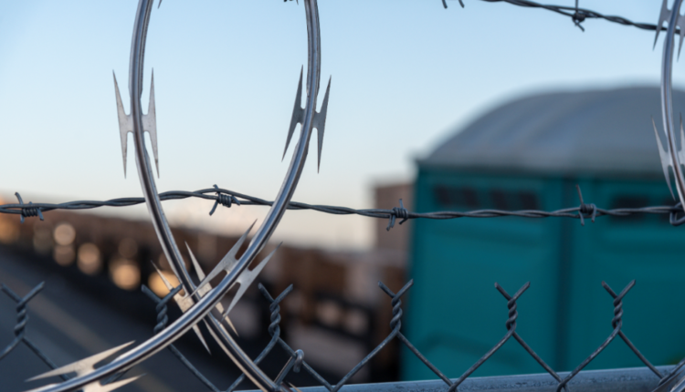 A close up on barbed wire outside a possible prison or jail facility