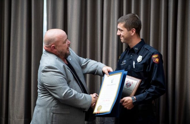 Madison County Commissioner Carl Alexander presents Firefighter Daniel Beck of the Madison County Fire Department with a proclamation declaring September 20, 2022, as 'Daniel Beck Day' in Madison County after he was named 'Firefighter of the Year' at the Jackson Exchange Club meeting on Tuesday, September 20, 2022. 