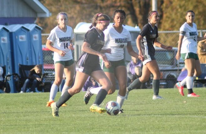Madison defender Taylor Tucker stays close to Lexington's Allie Parker in Saturday's Division II Sectional final that Lexington won on penalty kicks.