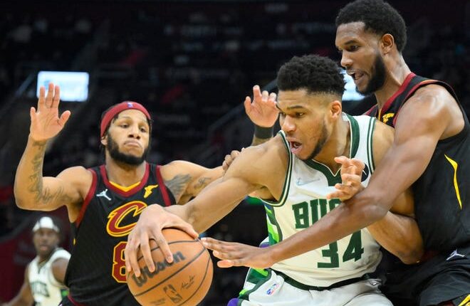Cleveland Cavaliers forward Lamar Stevens and Evan Mobley (left) defend Bucks forward Giannis Antetokounmpo in the third quarter Wednesday night.