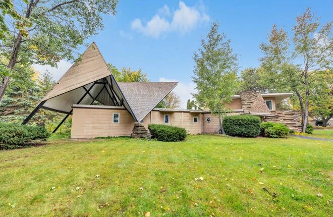 The custom-built, mid-century modern home at 3200 Waubenoor Dr., Allouez, features a parabolic roof that juts up from the 4,300-square-foot residence.