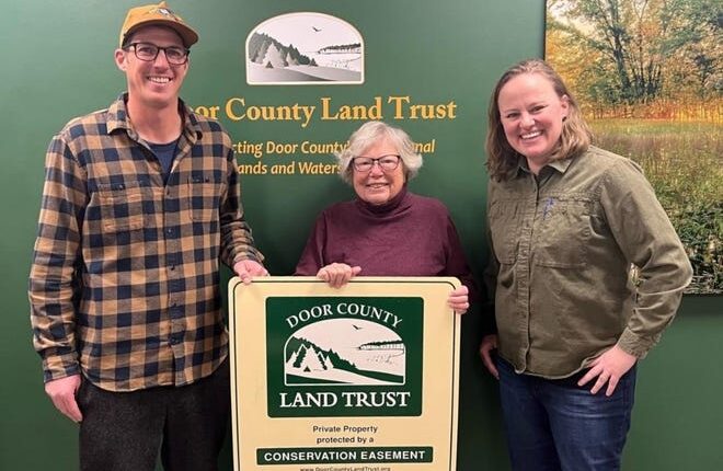 Patricia Nell, center, joins conservation easement program manager Drew Reinke, left, and executive director, Emily Wood, at the Door County Land Trust offices in Sturgeon Bay.