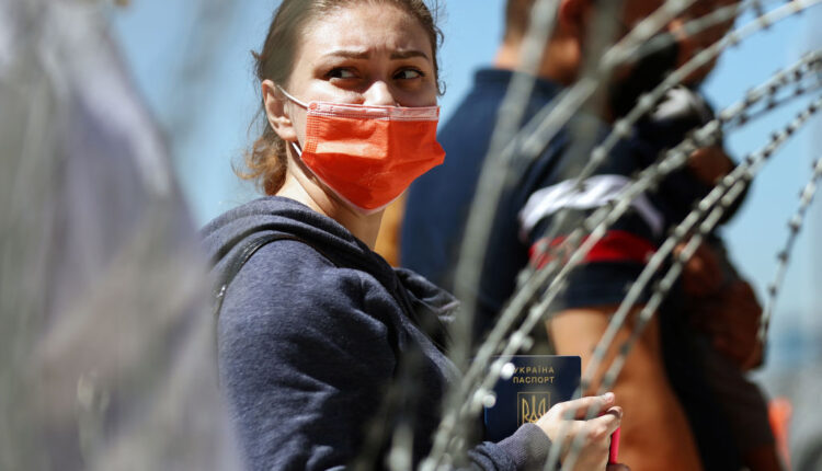 TIJUANA, MEXICO - MARCH 22: A refugee holds her Ukrainian passport before being allowed to cross the San Ysidro Port of Entry into the United States to seek asylum on March 22, 2022 in Tijuana, Mexico. U.S. authorities have been allowing Ukrainian refugees to enter the U.S. at the Southern border in Tijuana with permission to remain in the U.S. on humanitarian parole for one year. (Photo by Mario Tama/Getty Images)