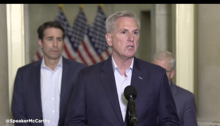 U.S. House Speaker Kevin McCarthy, front, with GOP Rep. Garret Graves of Louisiana at left, speaks briefly to reporters about a deal on the debt ceiling he said has been reached with the White House, on May 27, 2023. Screenshot from speaker's office webcast.