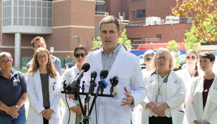 Dr. Matt Hoffman, a family physician at Allina Vadnais Heights Clinic, speaks at a news conference outside Allina Abbott Northwestern Hospital on Aug. 16, 2023, announcing a group of more than 550 primary care clinicians filed for a union election with federal labor regulators. Photo by Max Nesterak/Minnesota Reformer.